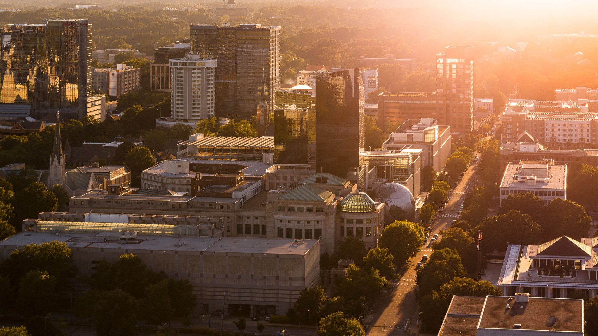 Sunset beams cover the Business District of Raleigh, NC. First Baptist Church stretching W Jones Street